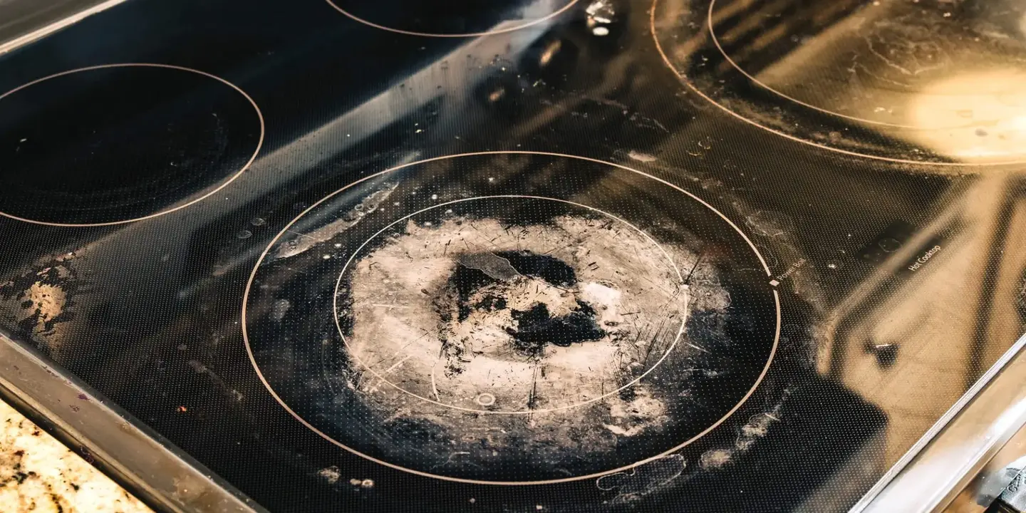 Cracked glass cooktop surface on a stove in need of repair
