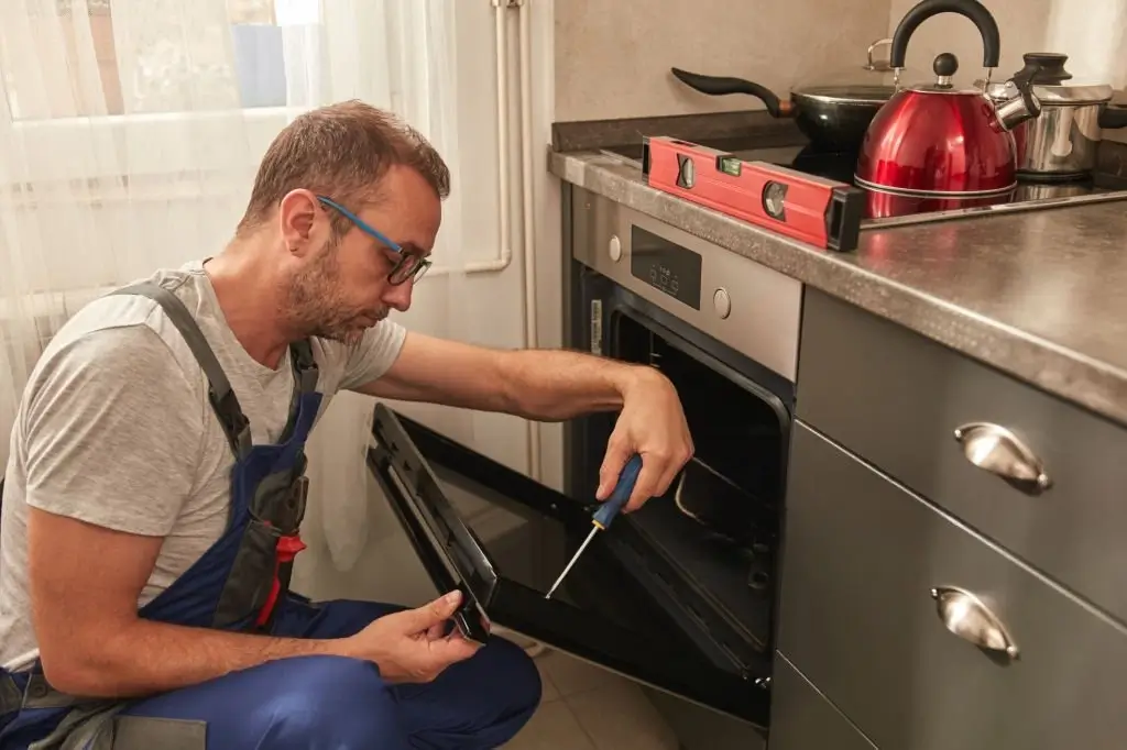 A Fasteny Repair oven technician in to fix a built-in stainless steel oven.